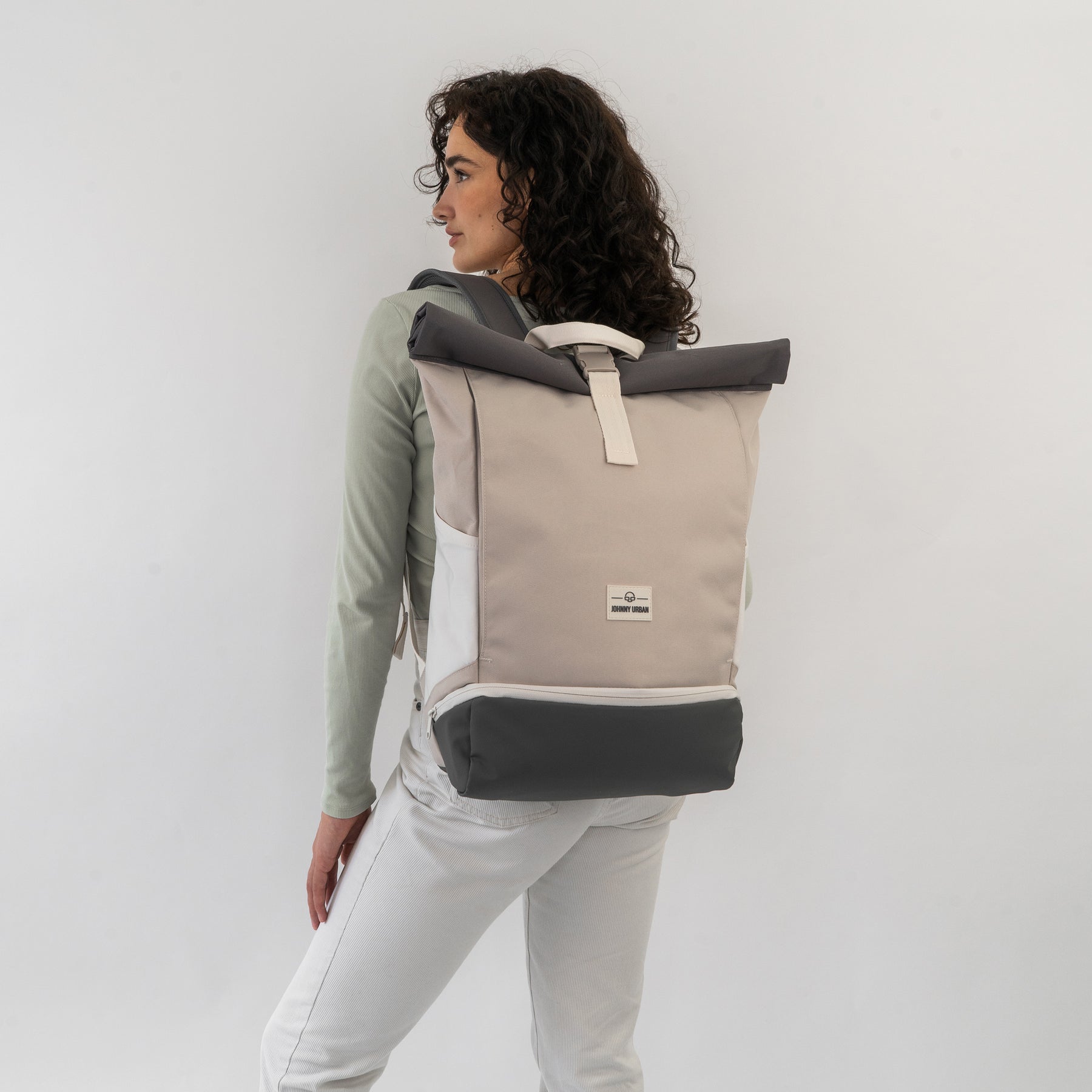 Frau trägt Rolltop Rucksack 'Allen Large' in Beige und Grau, seitliche Ansicht