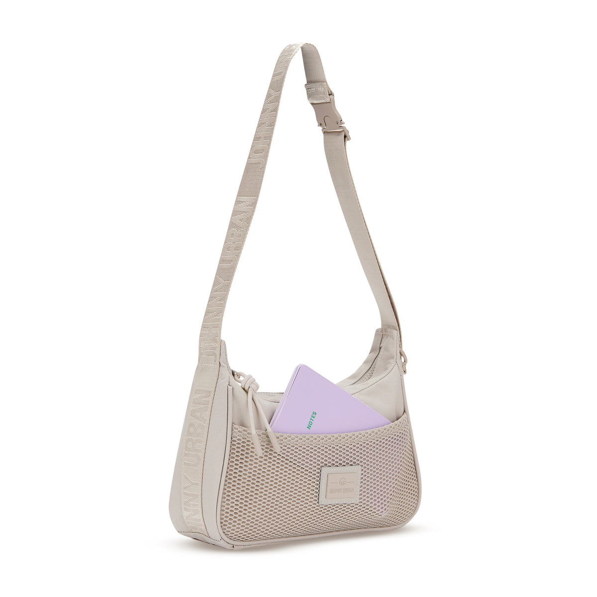 Beige Handtasche 'Maddy' mit Netzvortasche und verstellbarem Schulterriemen, lila Notizbuch steckt in der Tasche